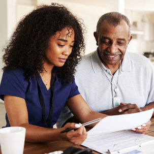 caregiver and senior woman reading a document