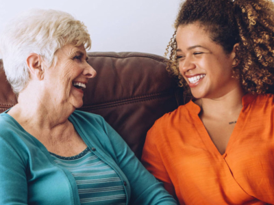 elderly woman and caregiver laughing